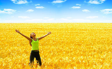 A happy young woman in the field