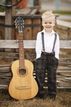 cute little boy with guitar on location
